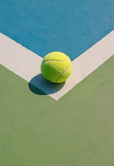 Tennis ball on a diagonal green and white surface
