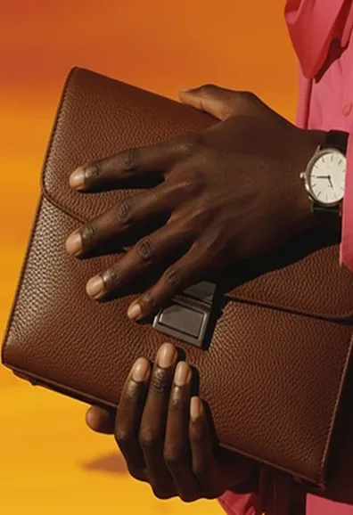 Close-up of hands holding a brown leather wallet