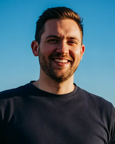 Portrait of a smiling bearded man in a dark shirt
