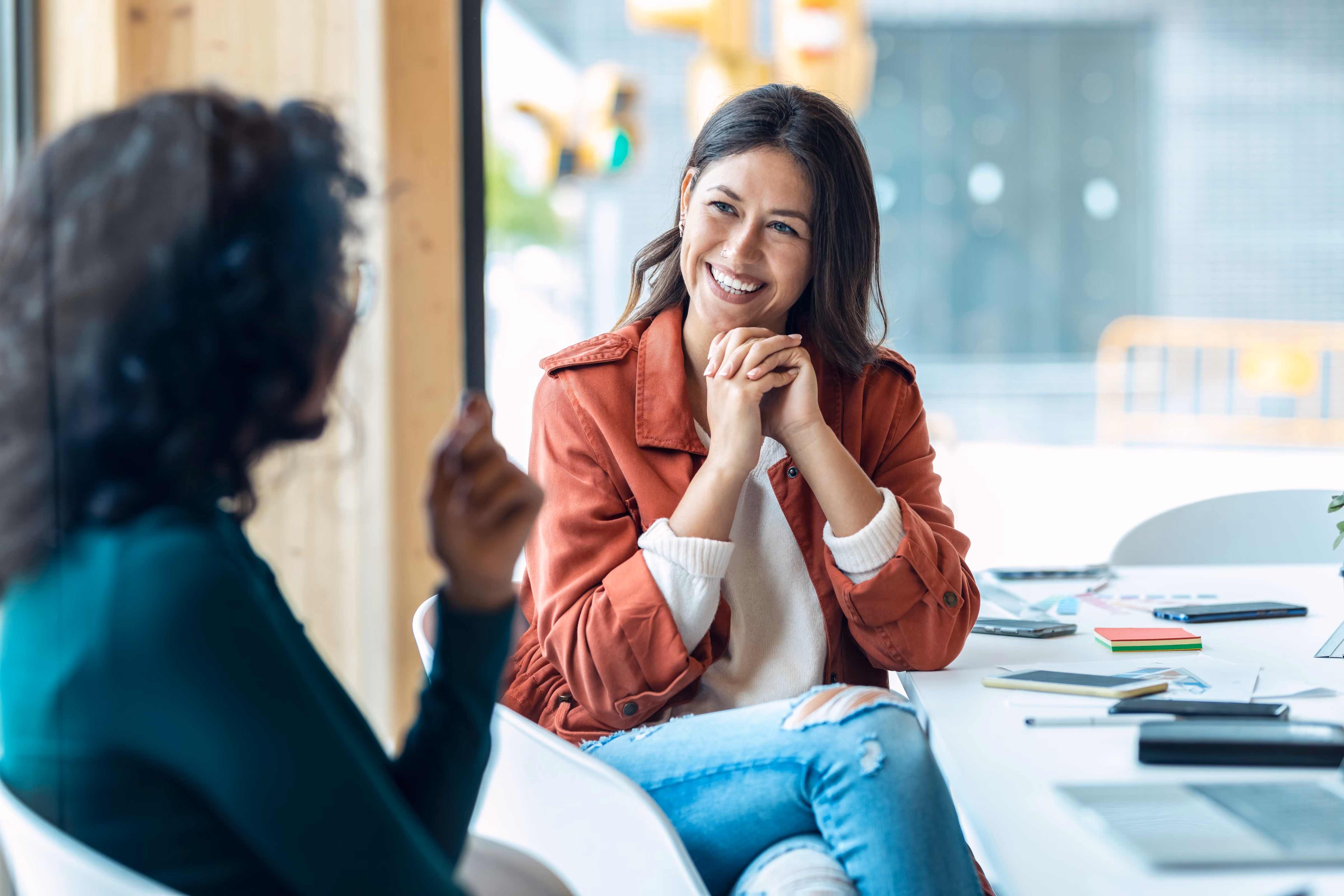 Woman looking at another woman stock image