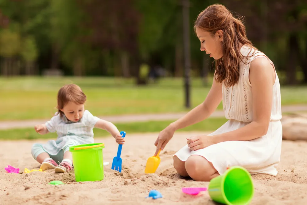 Woman and child digging together in a sandbox