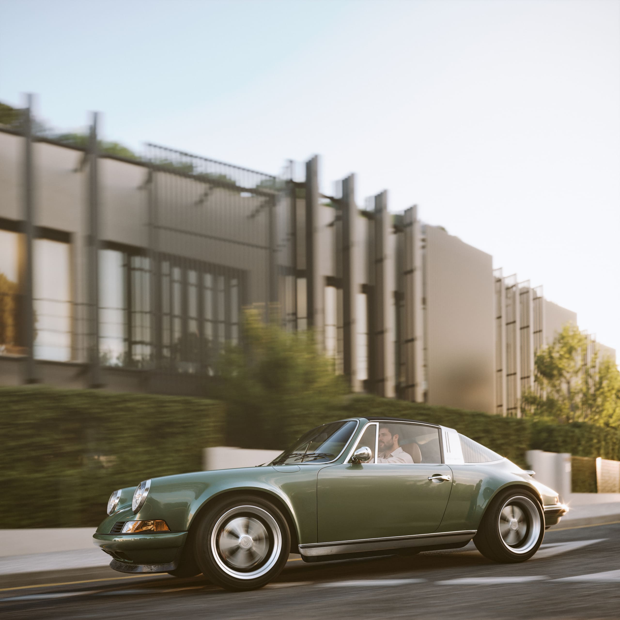 Green vintage sports car with a driver on a city street near modern buildings.