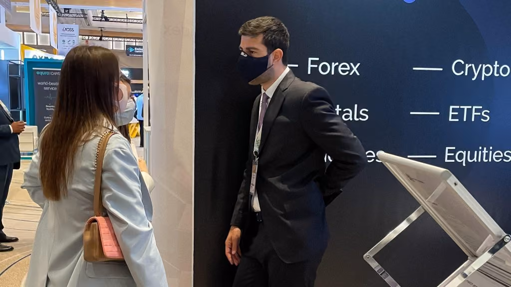 Andreas Kapsos, the CEO of the regulated liquidity provider Match-Prime, talking to an expo guest