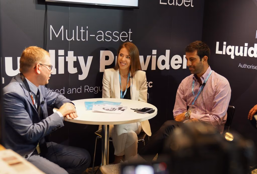 Interview being recorded at the Match-Prime stand, three people seated at a table