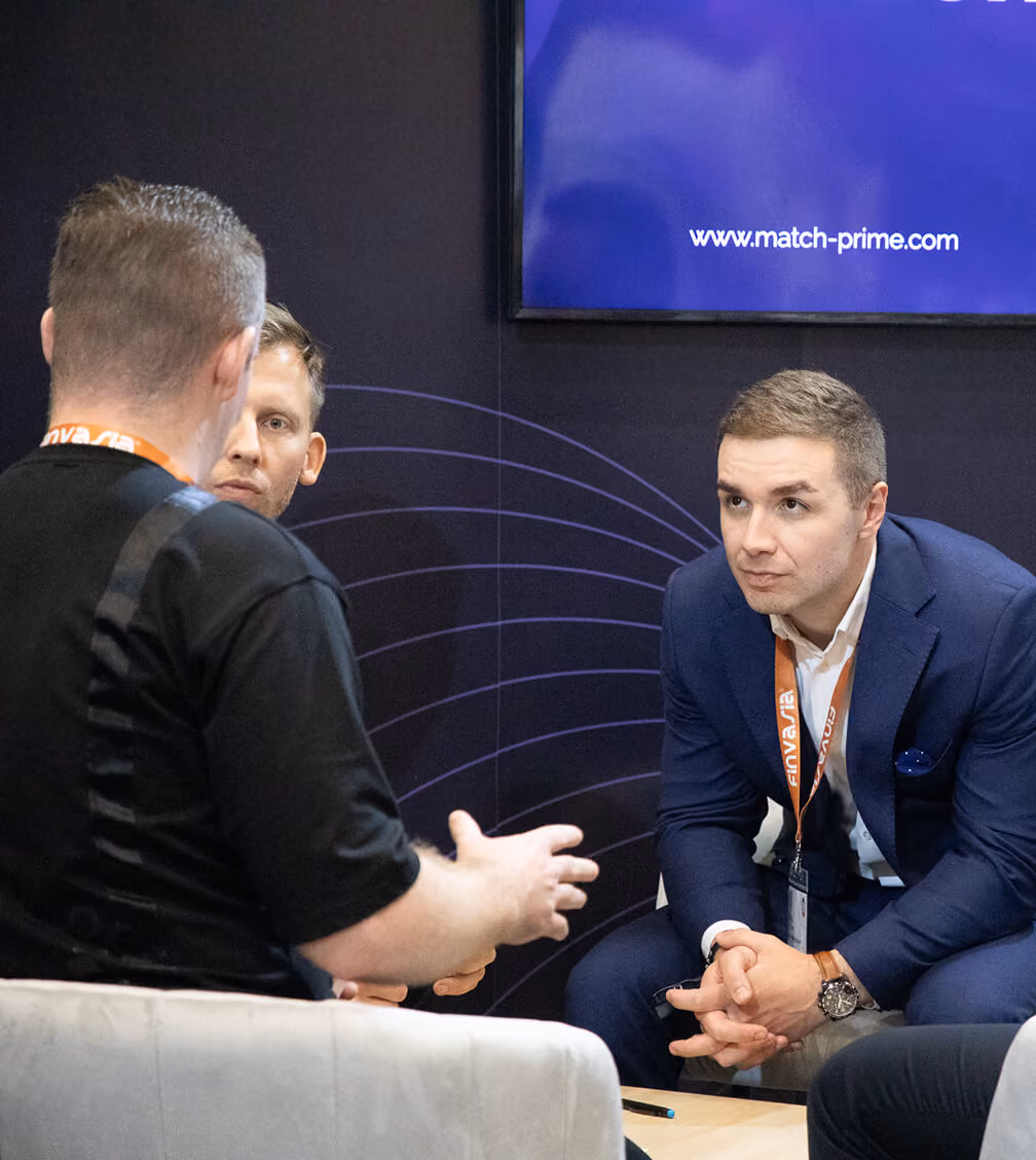 Match-Prime colleagues in conversation with a client at the company's expo stand.