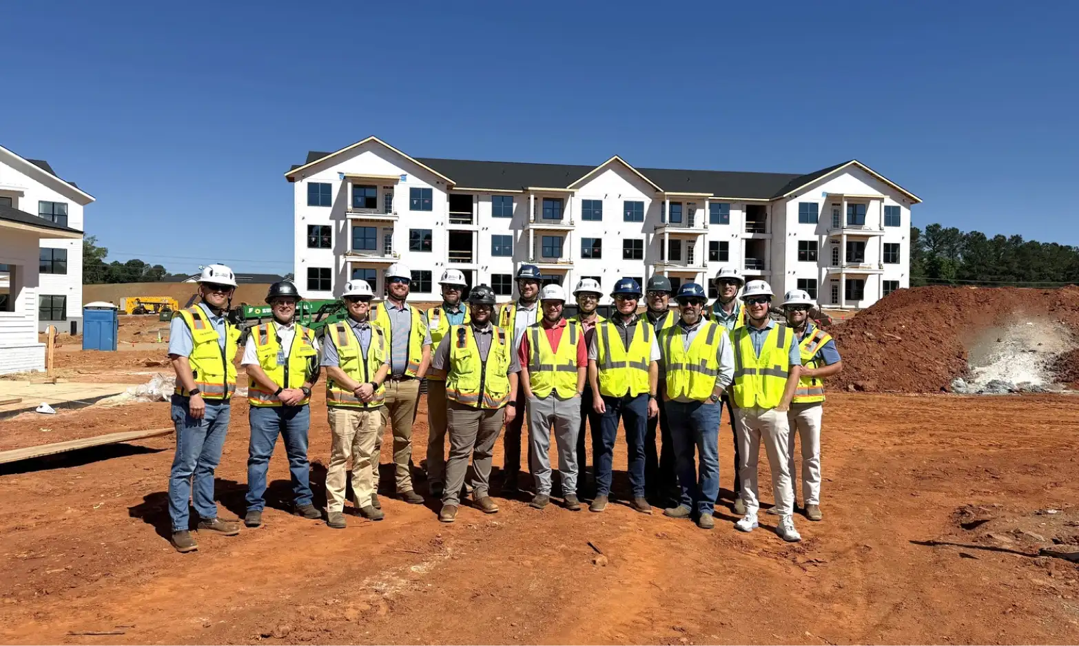 A group picture in front of a residential development job site.