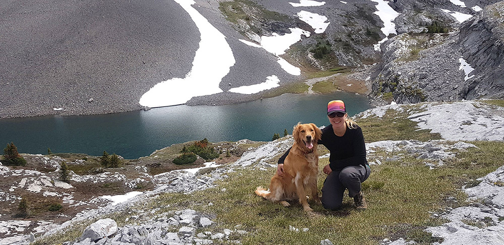 Alexandra MacIsaac and her dog hiking.