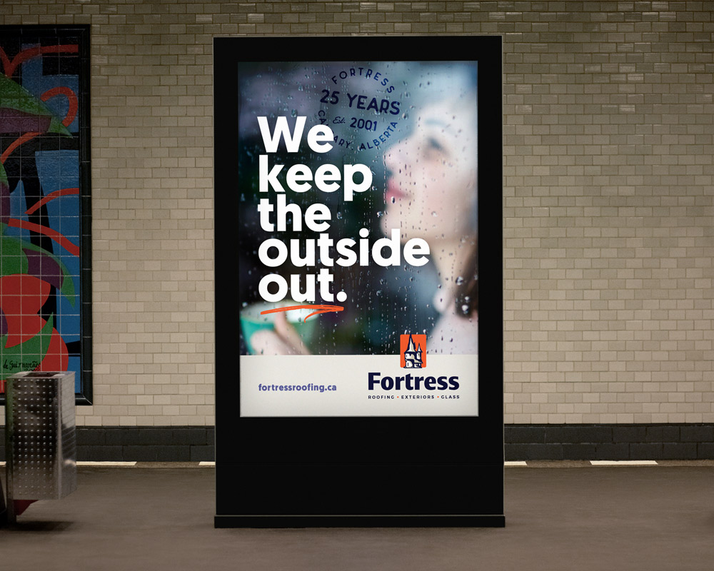 Backlit transit ad for Fortress Roofing showing raindrops on window glass with blurred woman behind it, featuring text: We keep the outside out, and Fortress logo with website fortressroofing.ca.