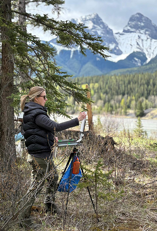 Portrait of Alexandra MacIsaac plein air painting in Canmore Alberta.