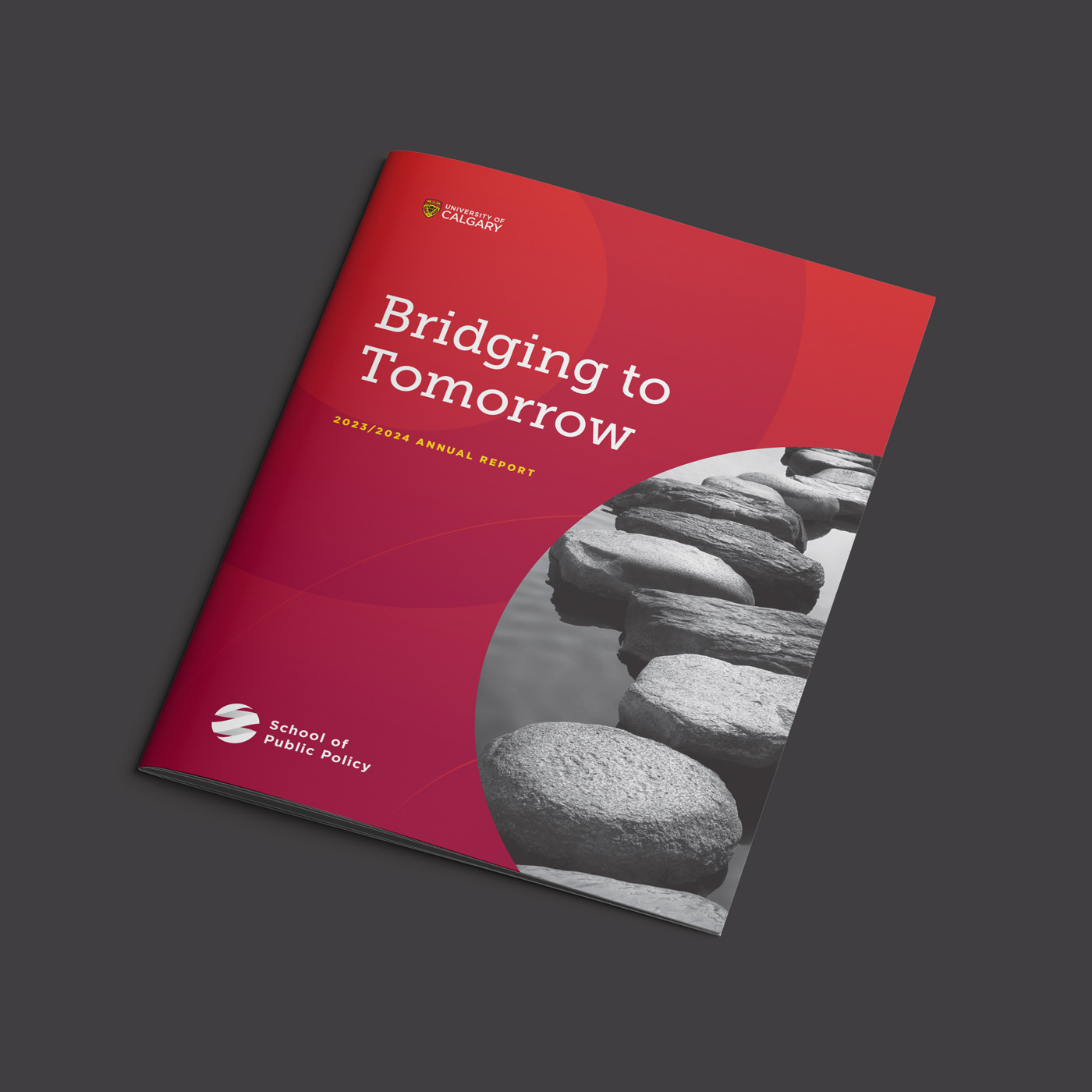 Cover of the University of Calgary School of Public Policy 2023/2024 annual report titled 'Bridging to Tomorrow,' featuring stepping stones across water on the bottom right.