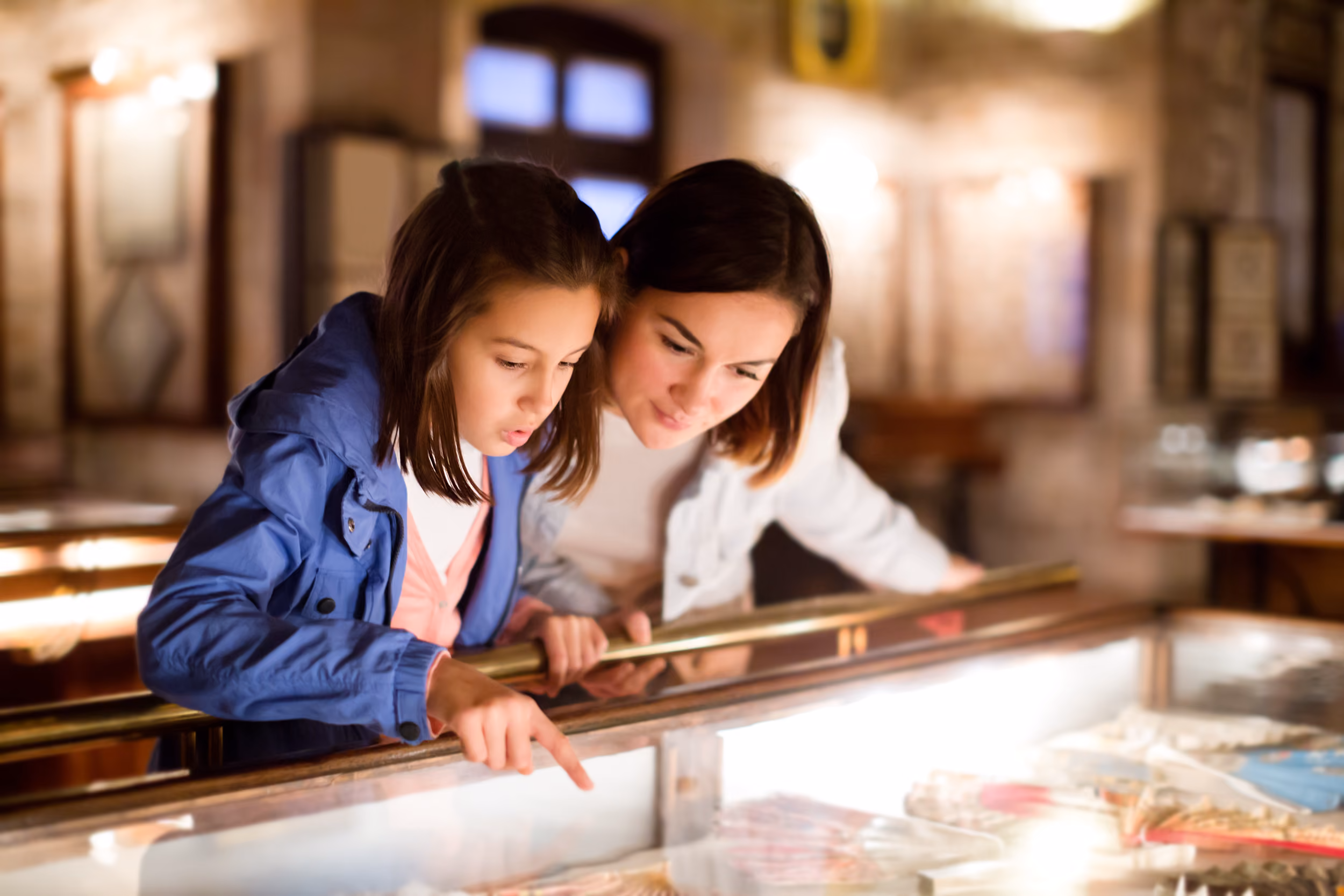 Mom and daughter looking at museum stock image