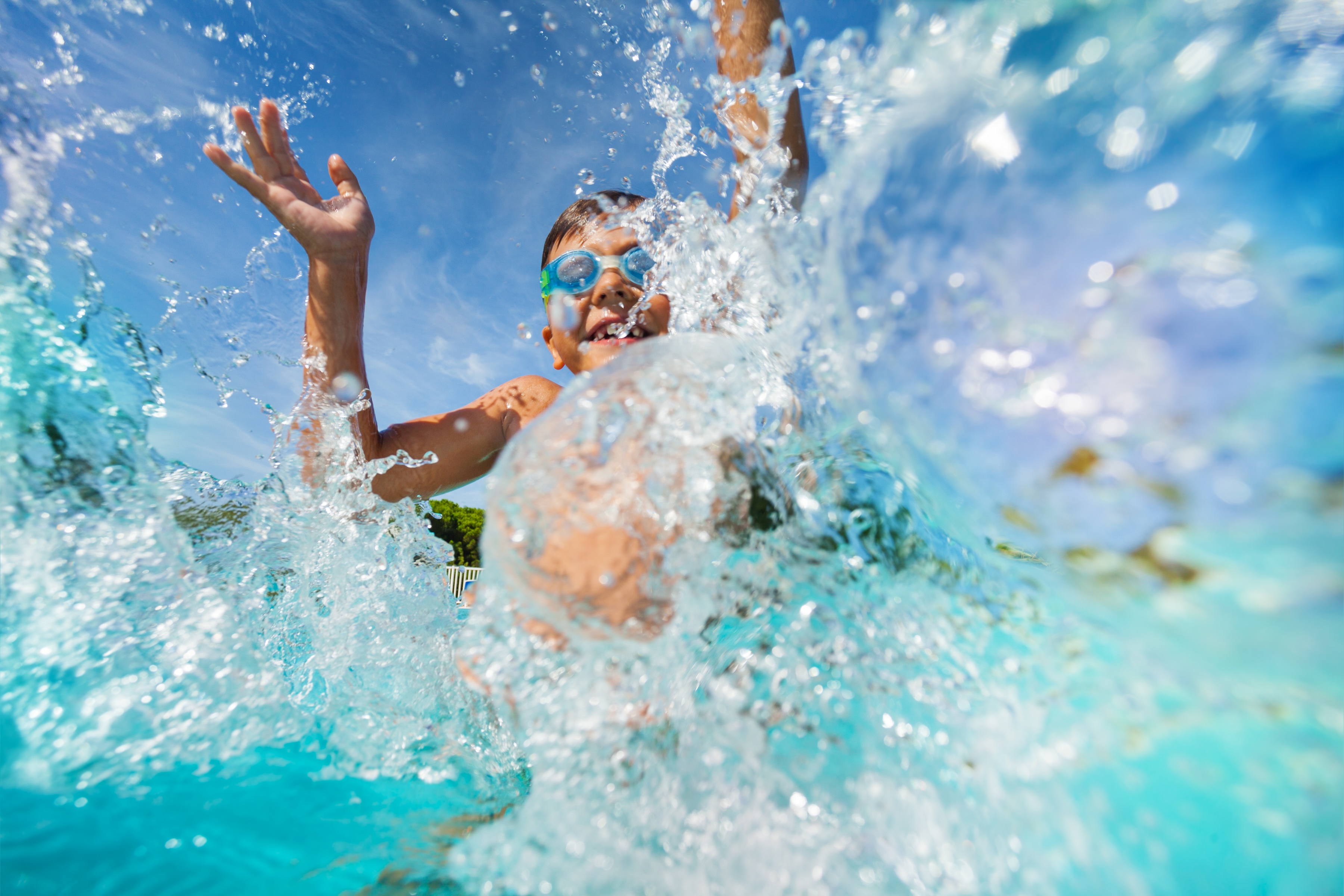 Kid playing in the pool stock image