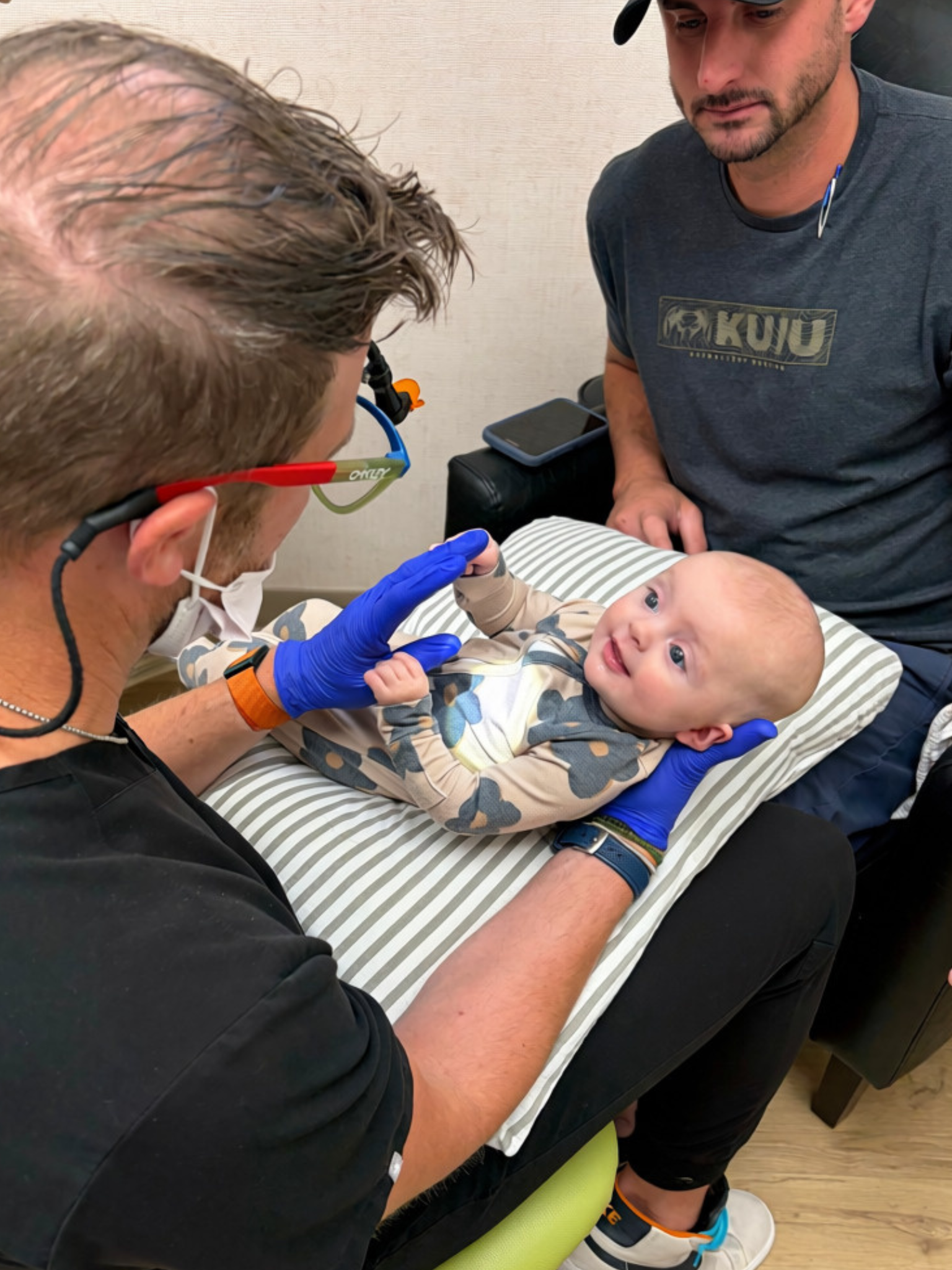 Baby calmly interacting with a Parkview provider during an oral-function visit.