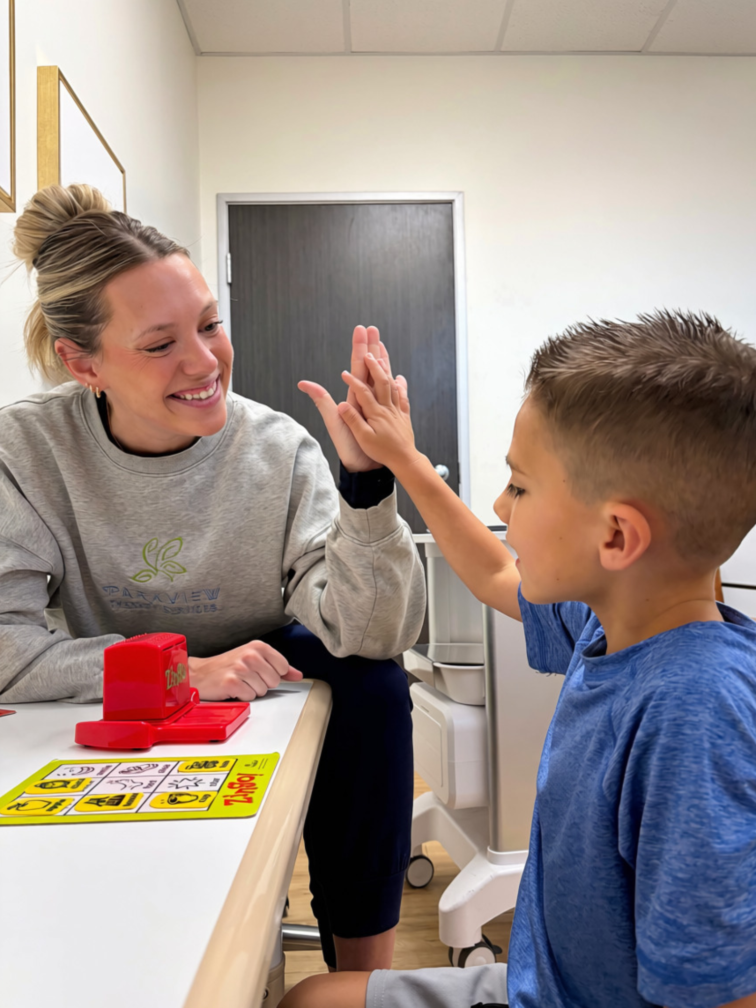 Parkview Therapy Services provider giving a child a high five during a therapy session.