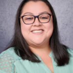 Misty Rodriguez staff directory photo smiling with glasses