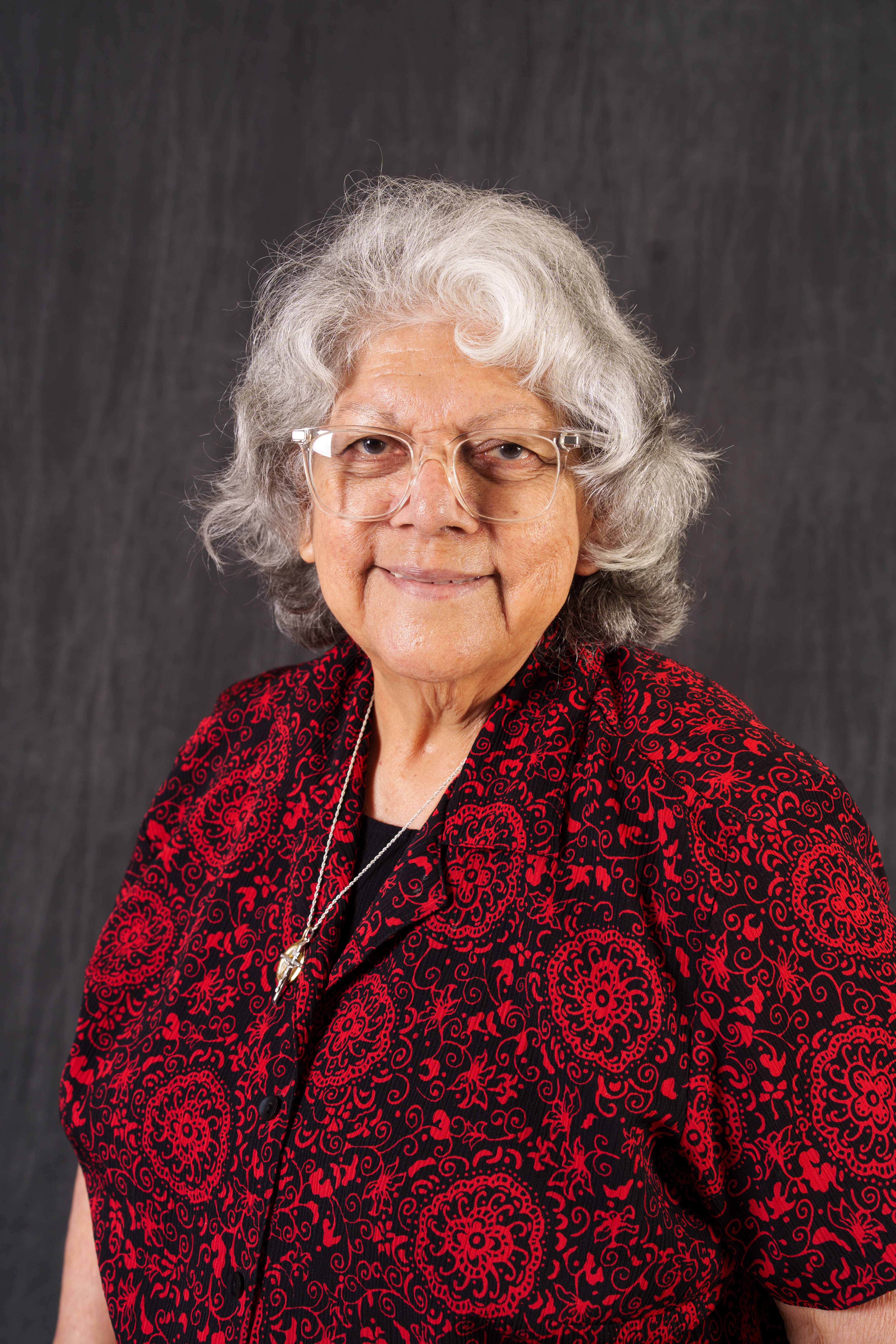 Tencha Rodriguez smiling in professional staff portrait photo