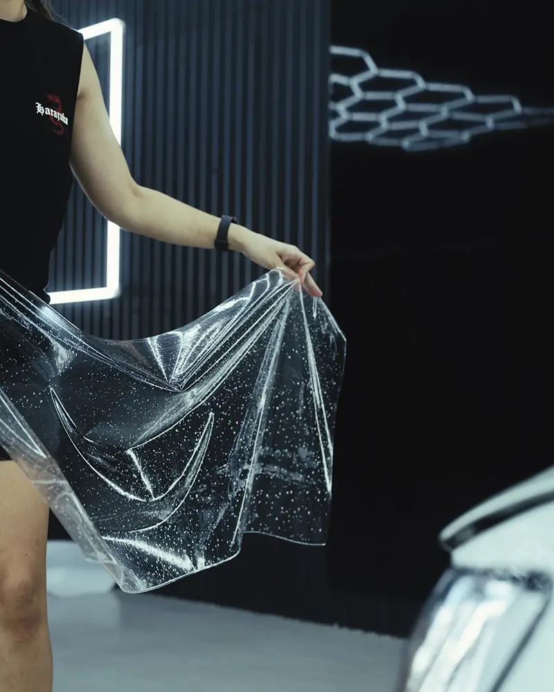 Ghostline staff member preparing Bushwrapz PPF Film for application
