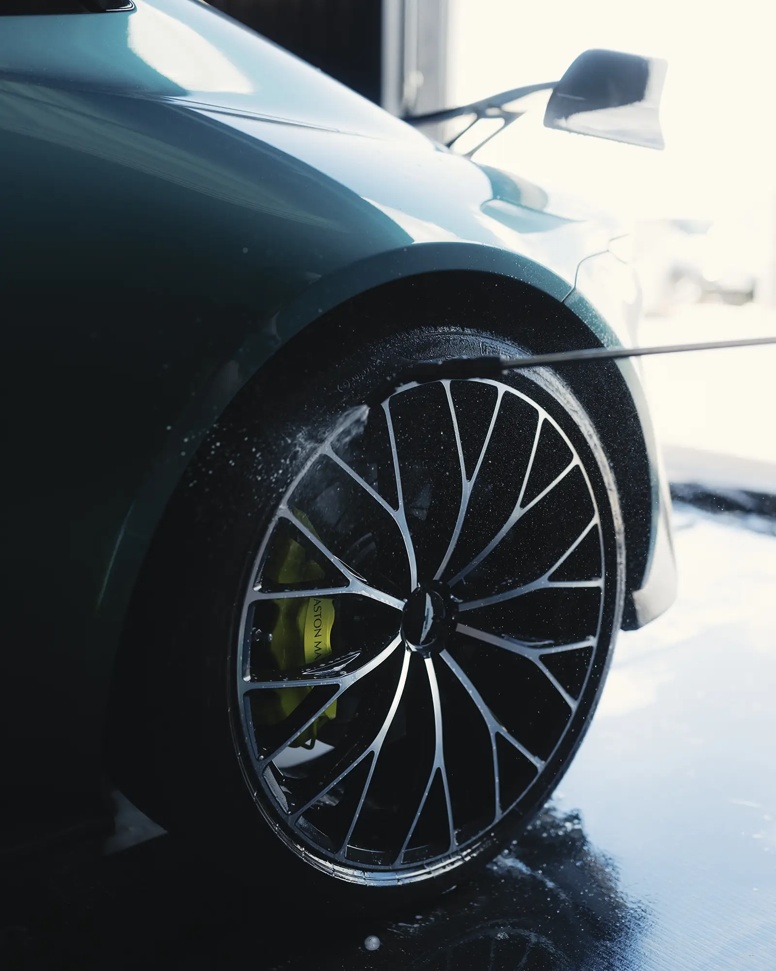 Newly washed rim on an Aston Martin.