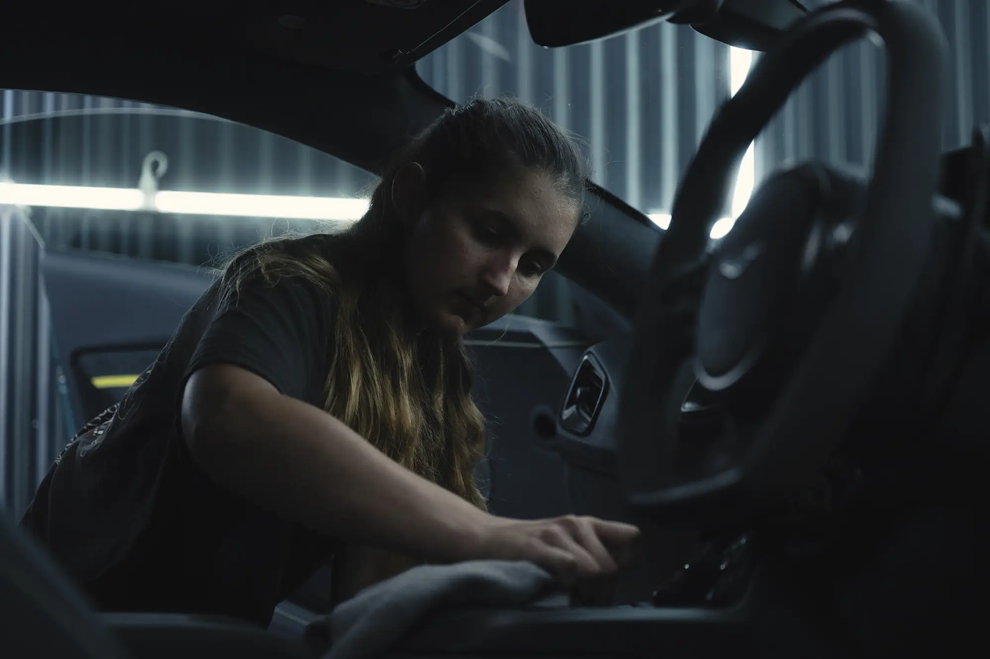 Ghostline Staff Member cleaning the inside of an Aston Martin