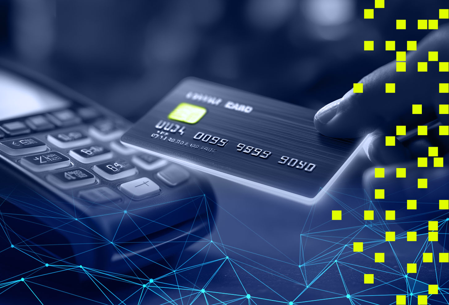 Hand holding a credit card near a keypad with digital network overlay.