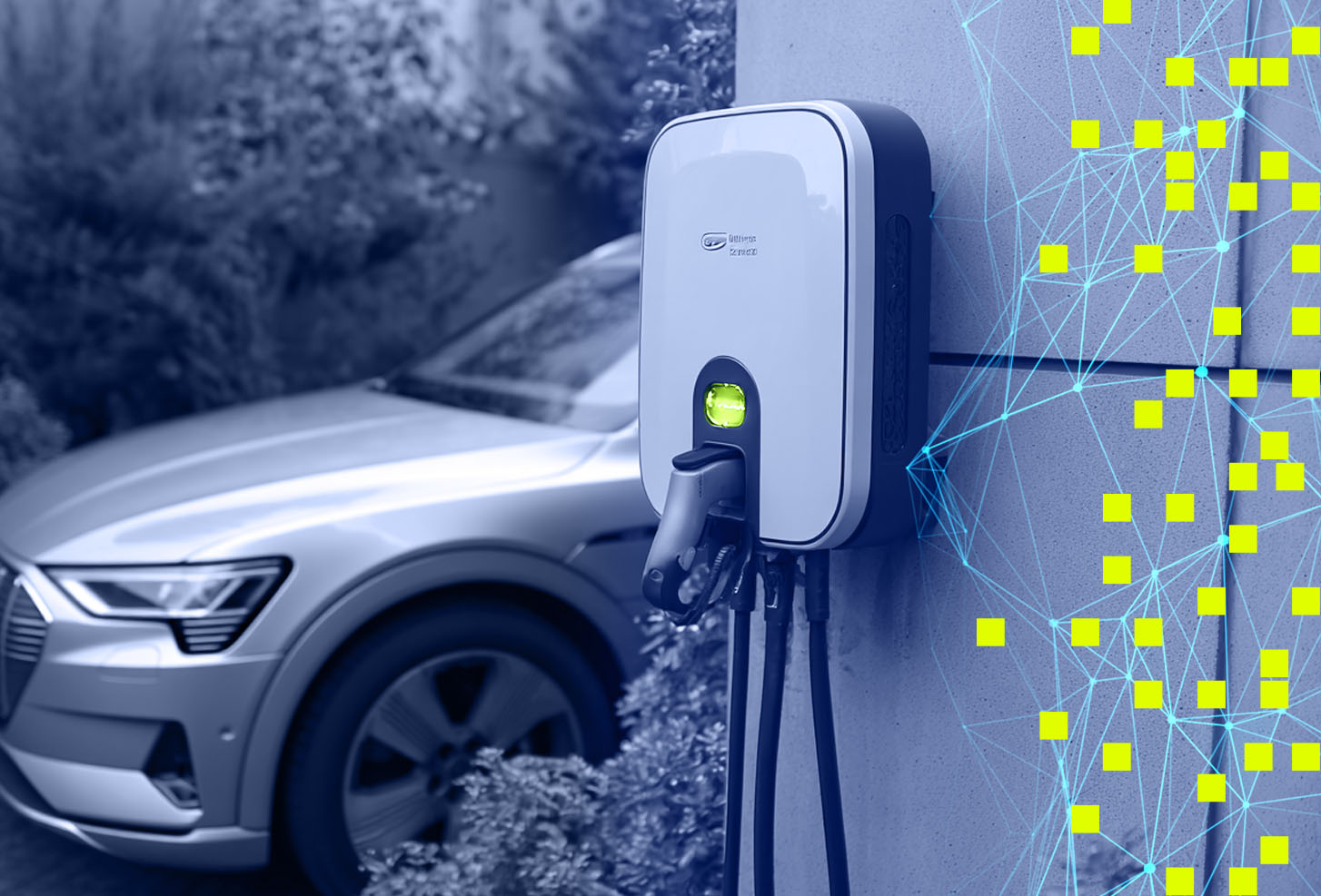 Electric vehicle charging station on wall with a car parked in the background outdoors.