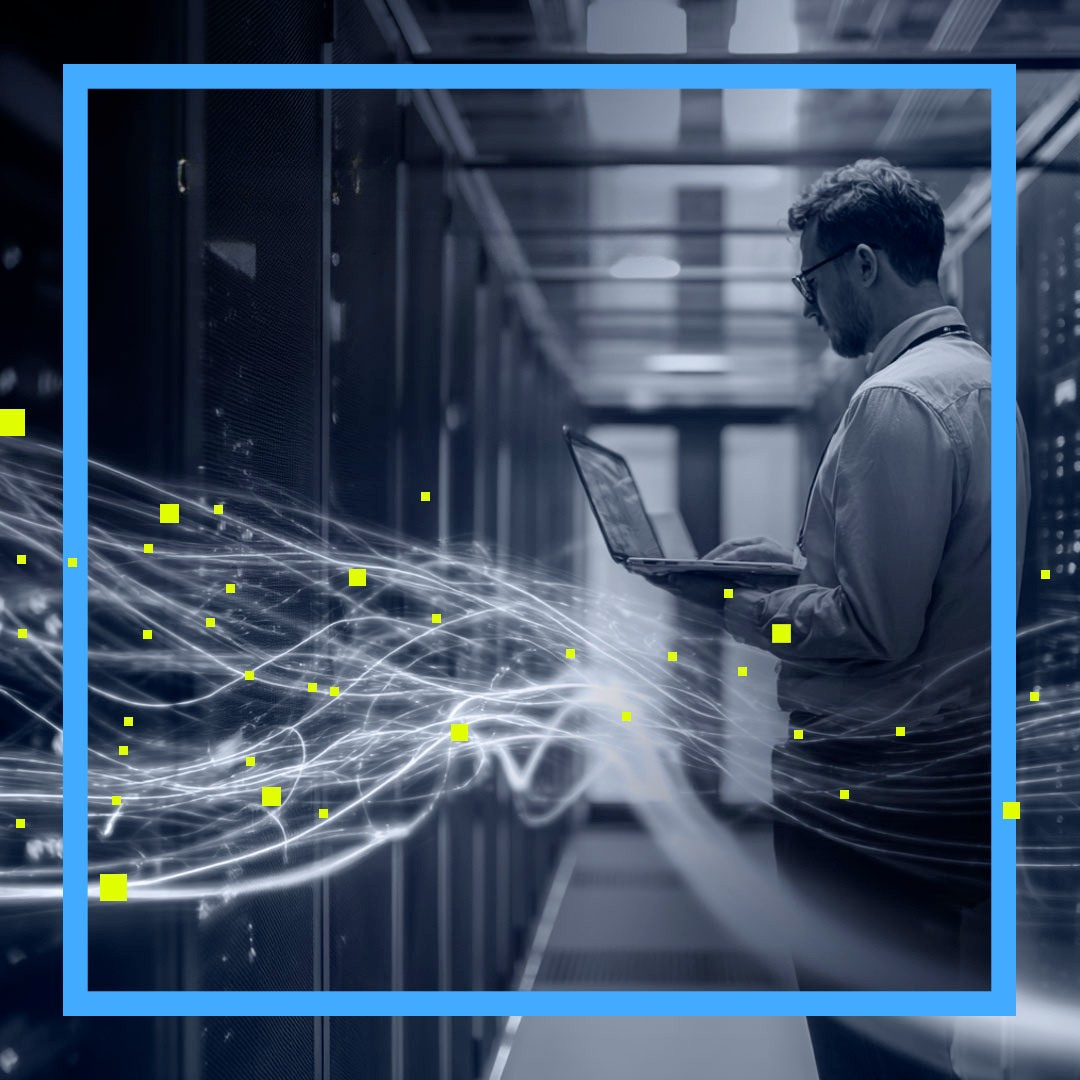 IT manager in server room checking connectivity with his laptop in hand
