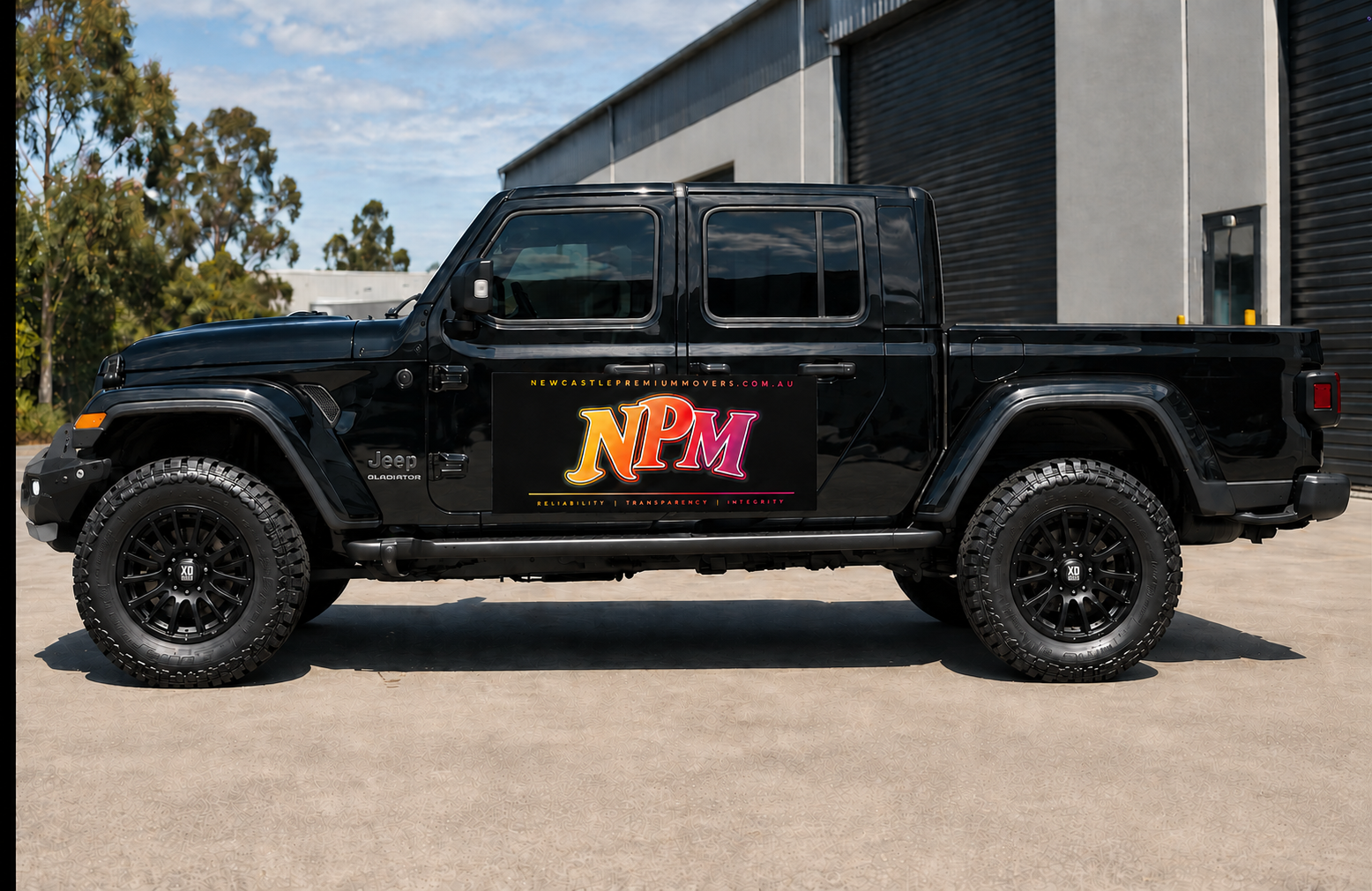 Newcastle Premium Movers branded black Jeep Gladiator.