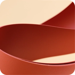 Close-up of curved red leather strips on a beige background.
