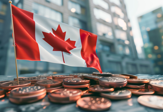 Small Canadian flag on a stick placed among stacks of Canadian pennies with blurred urban buildings in the background.