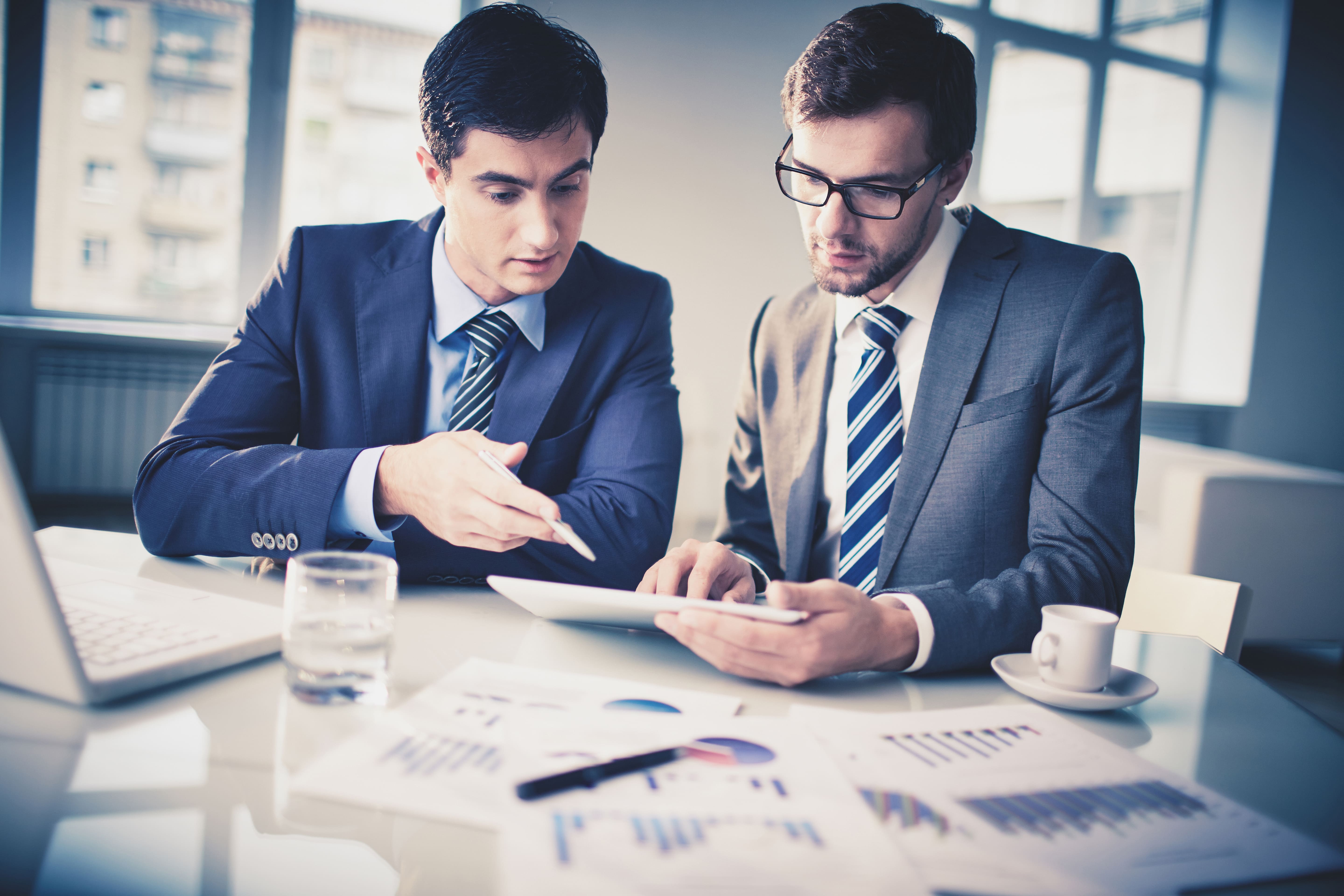 Two professionals reviewing a property valuation report
