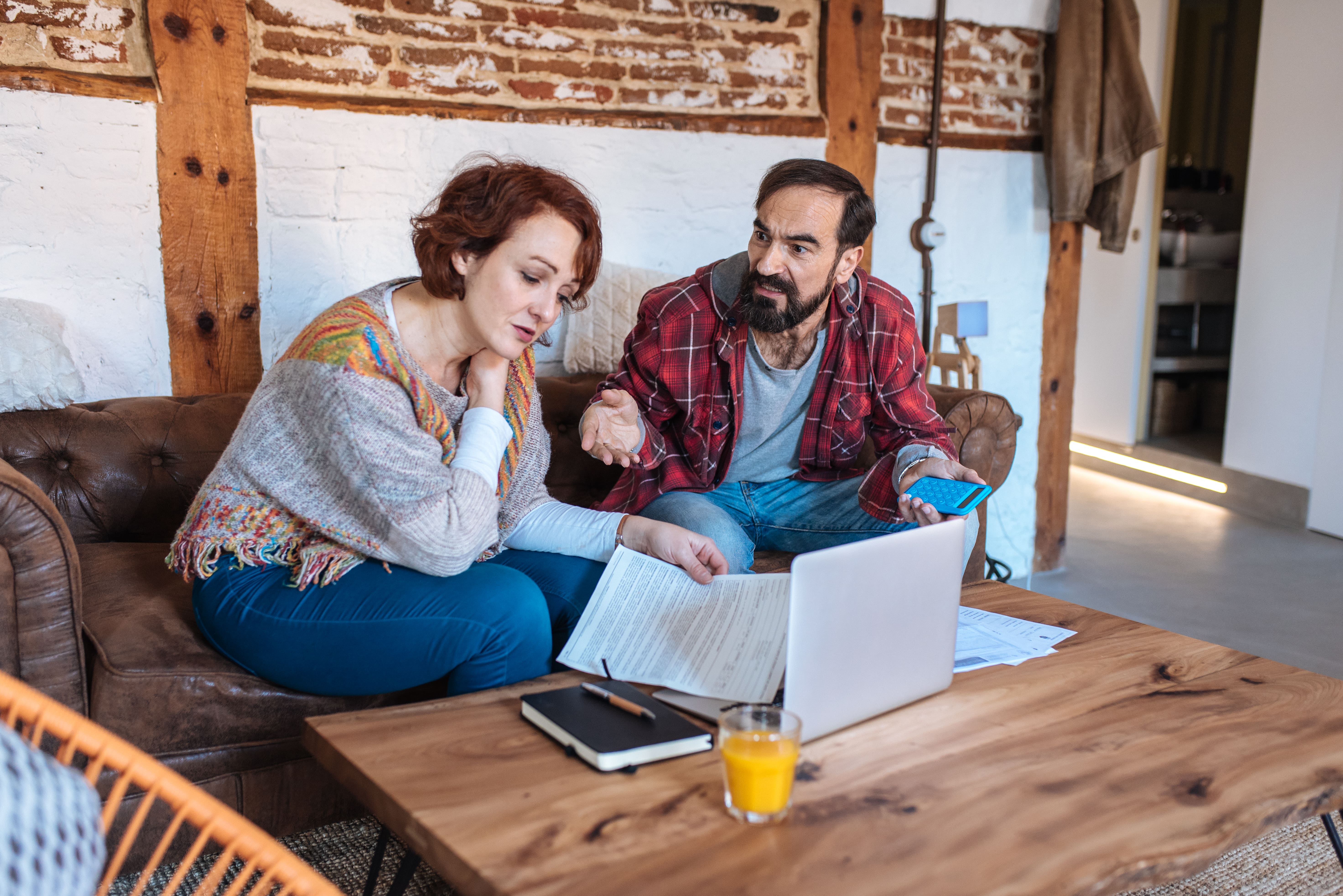 Couple at home reviewing their finances together