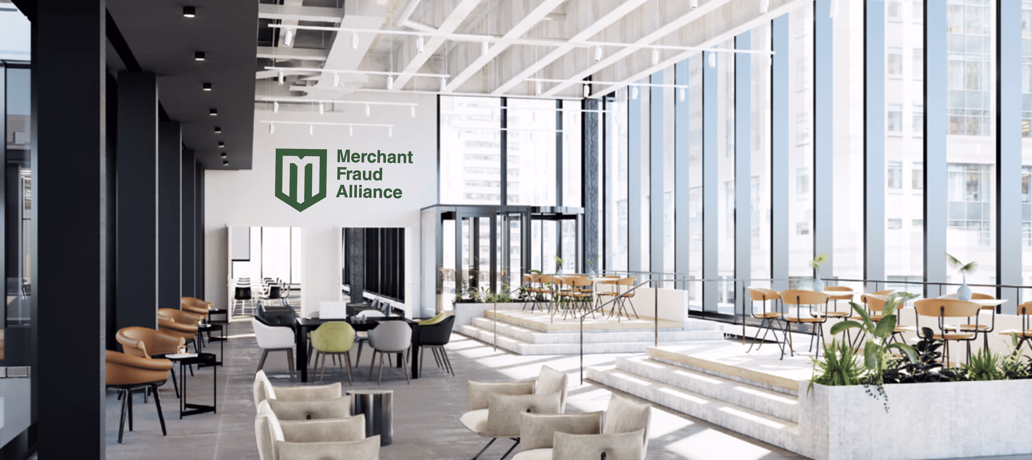 Modern office lounge with glass walls, varying seating, and Merchant Fraud Alliance logo on wall.