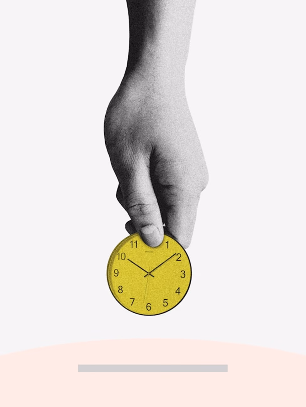 A hand holds a small yellow clock showing 10:10 against a plain background.
