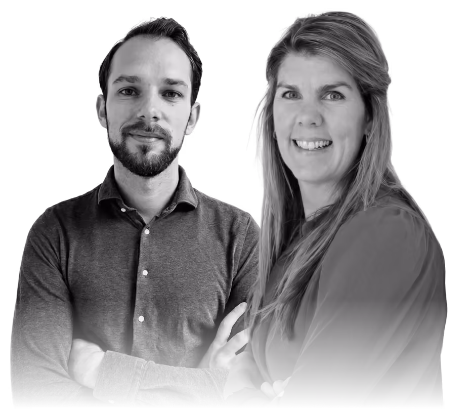 Smiling man and woman standing side by side with folded arms, looking at the camera.
