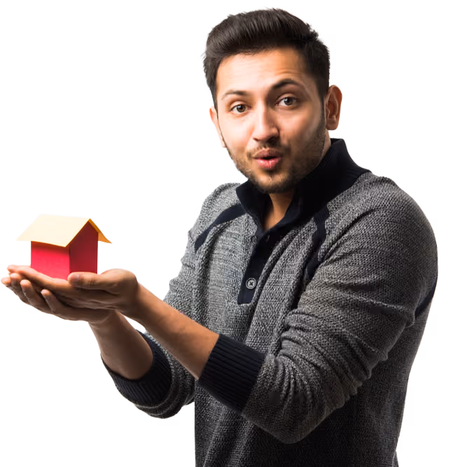 Man holding a small model house in his hand