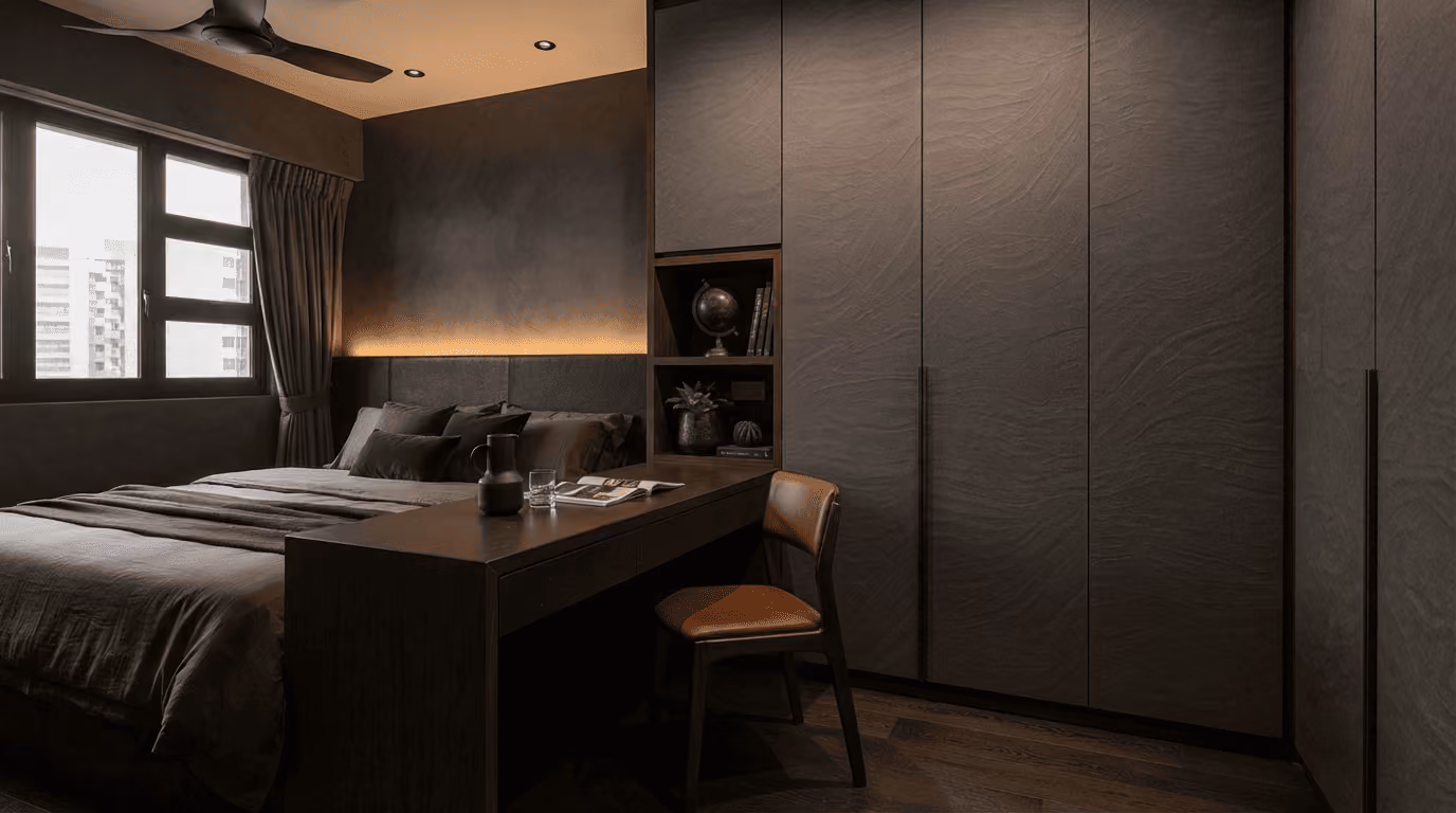 Modern bedroom with dark tones, large bed, desk with chair, built-in storage, and window with curtains.
