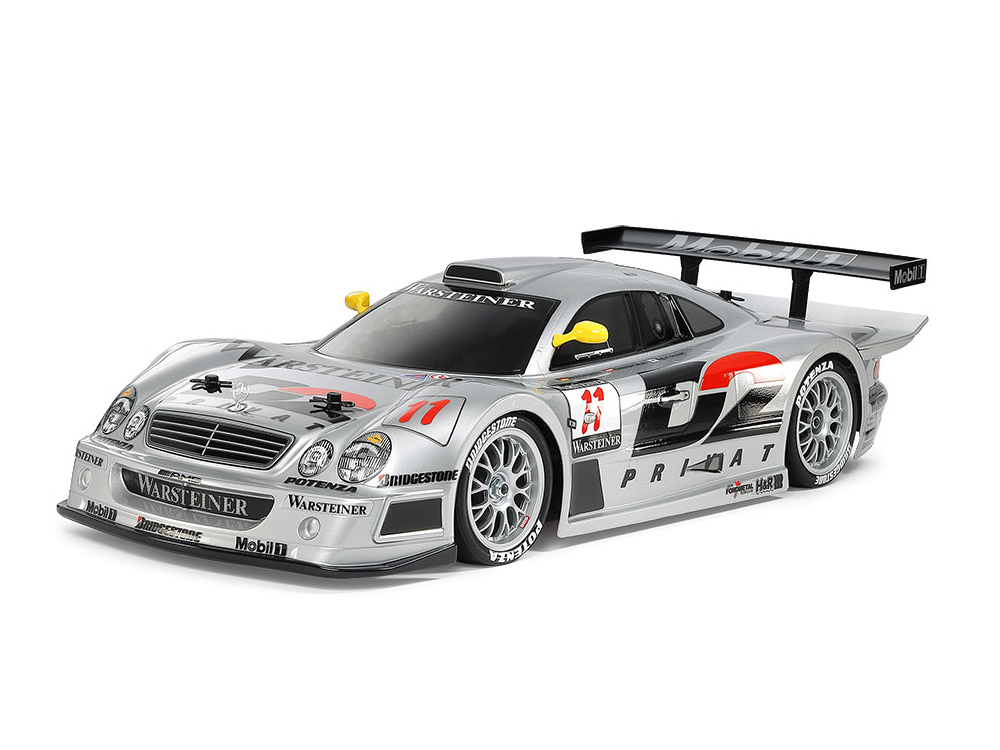 Silver Mercedes-Benz racing car with number 11, yellow mirrors, and a large rear wing.
