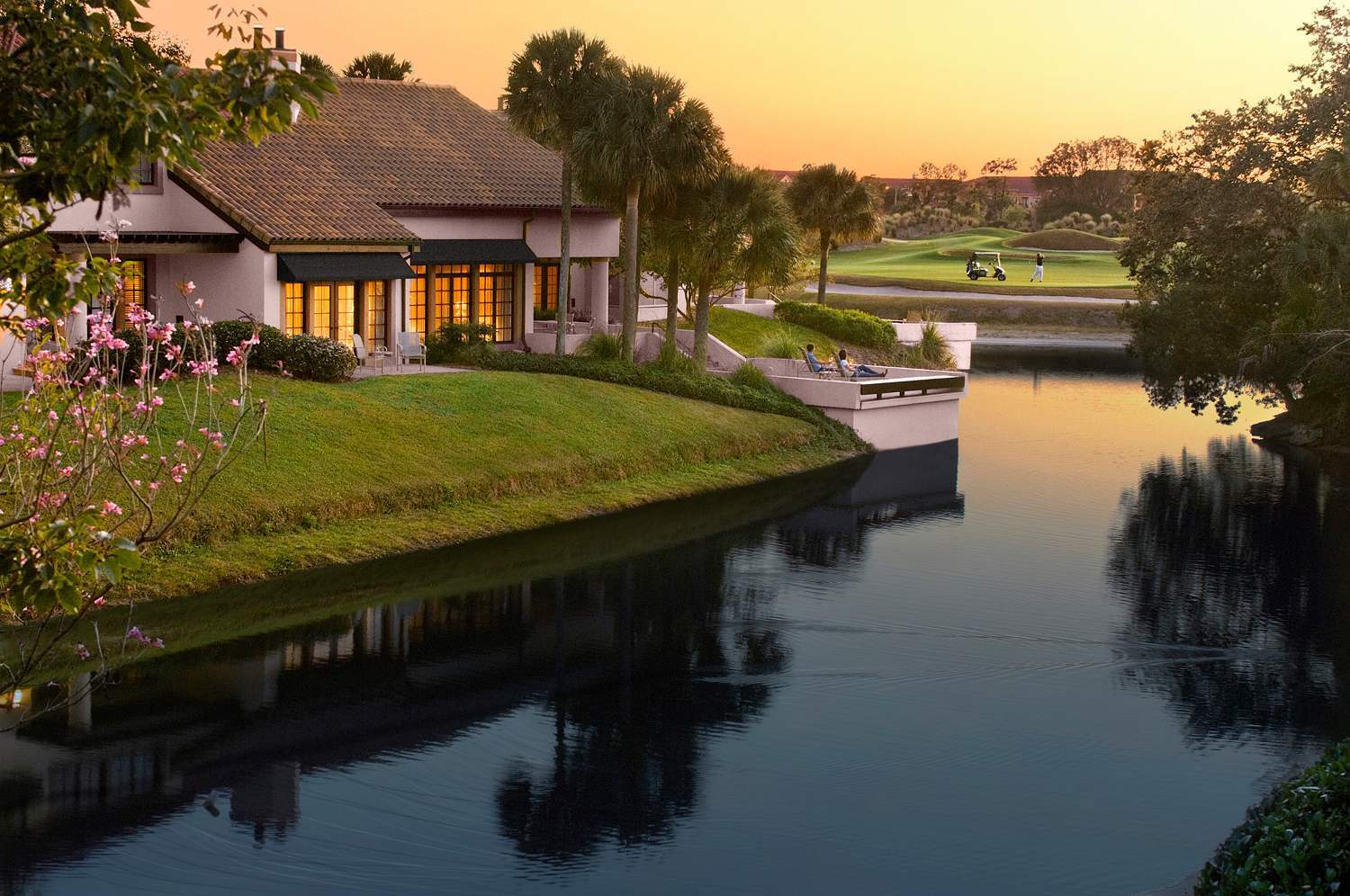 Evermore villa at sunset overlooking the golf fairway and waterway