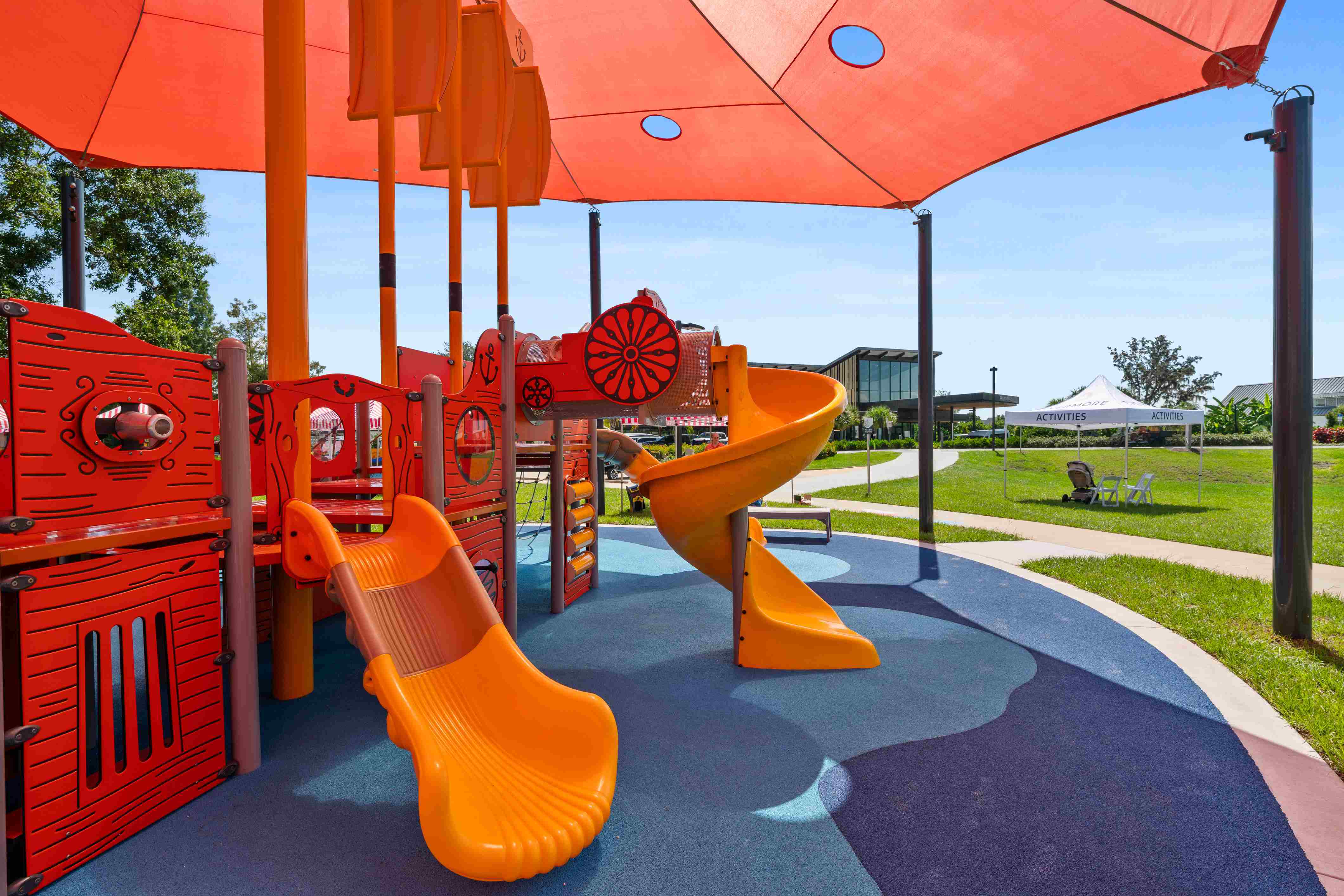 Evermore resort playground with slides under a shade structure
