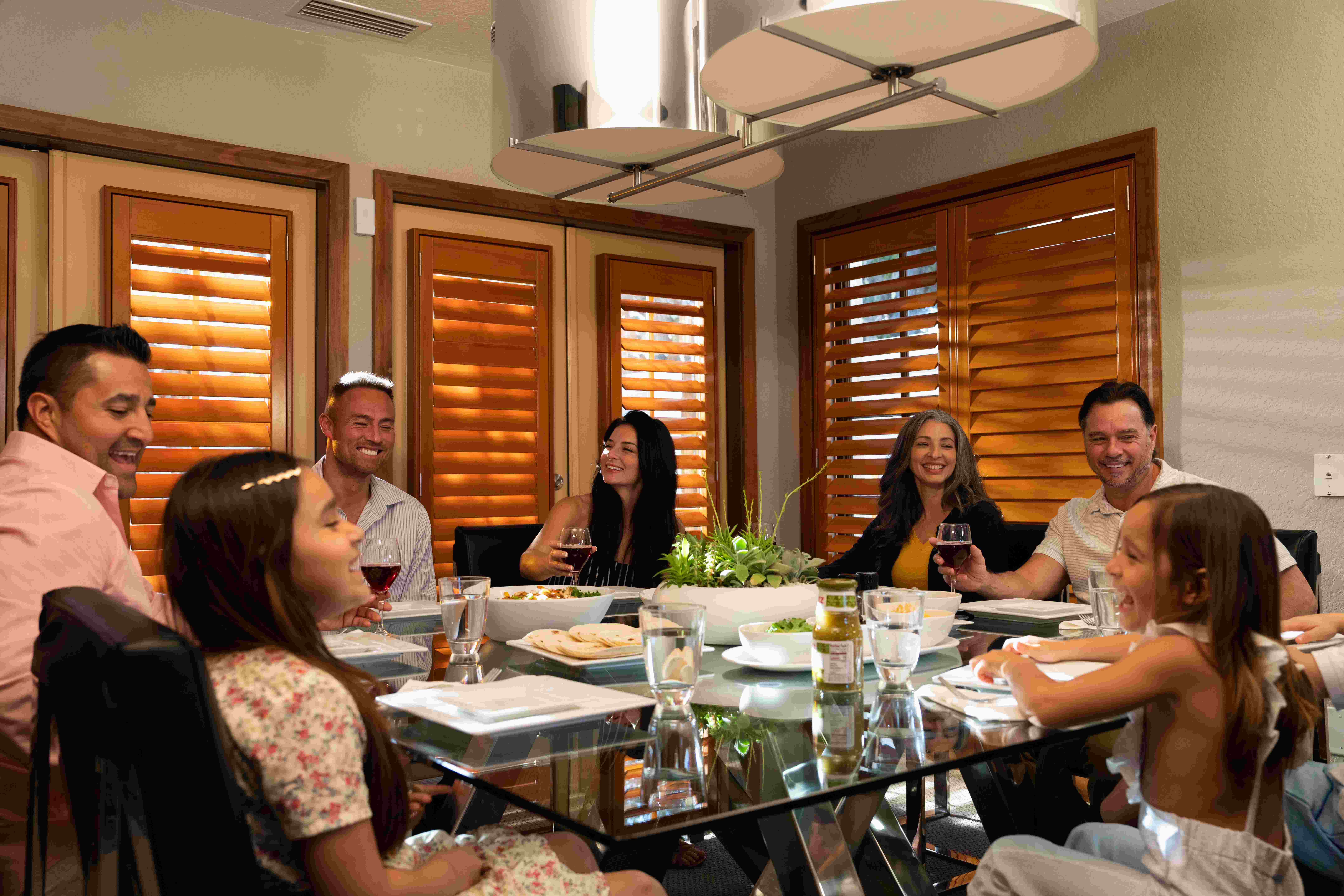 Family gathered around the dining table in an Evermore Villa