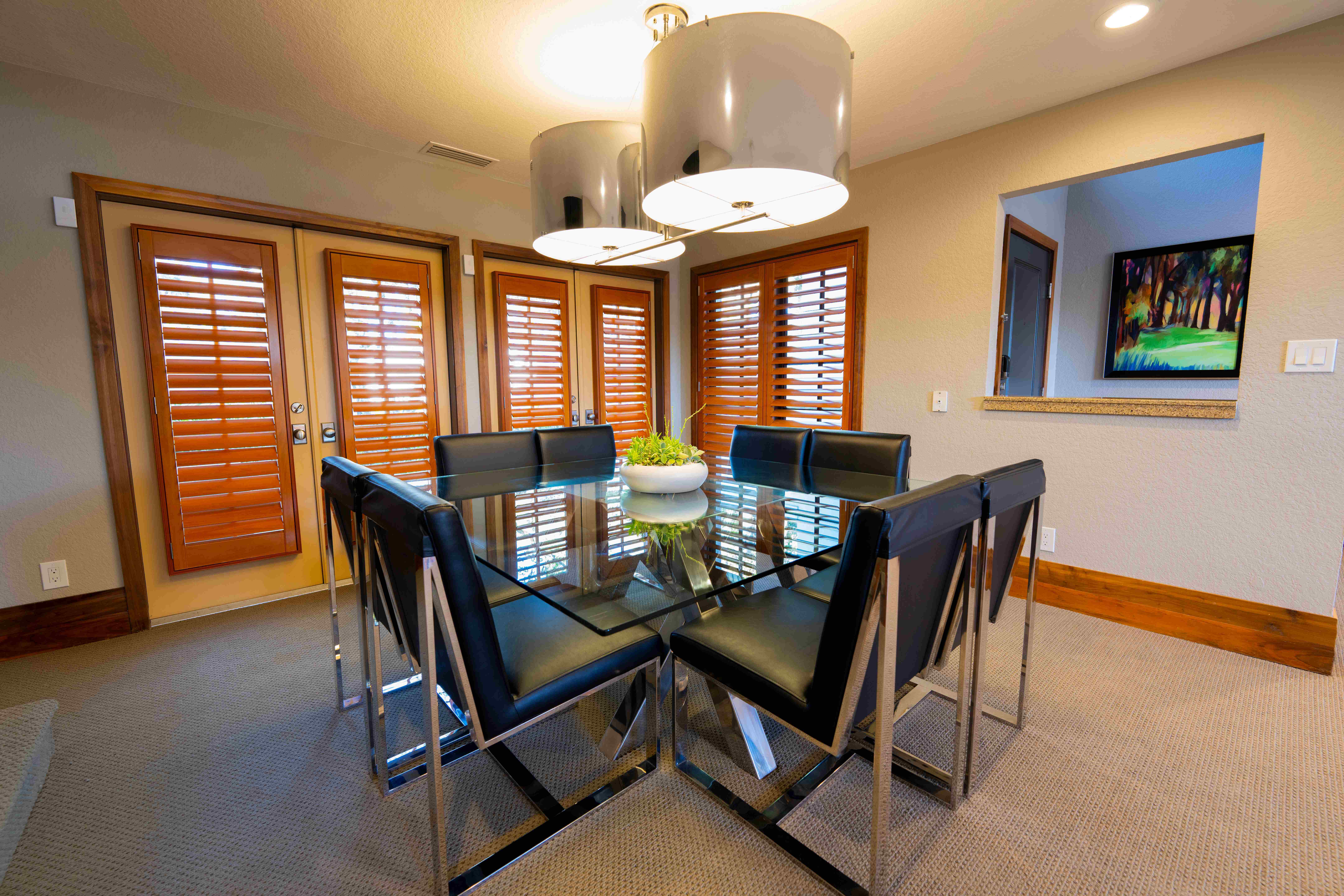 Villa dining room interior with glass table and modern lighting
