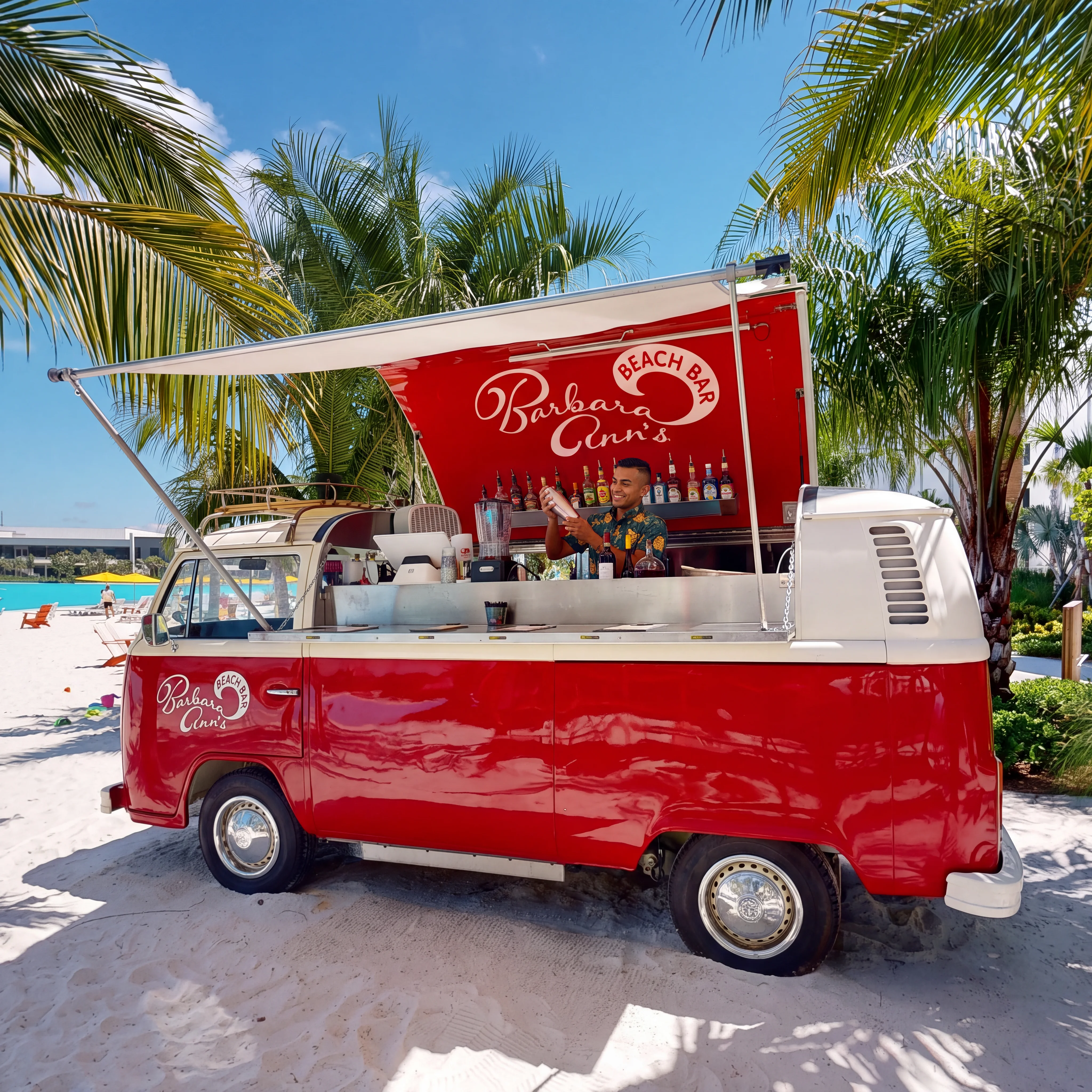 Red vintage van converted into a beach bar with a bartender shaking a cocktail on sandy beach.