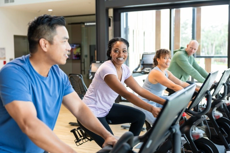 Guests riding Peloton bikes in the Evermore Fitness Center