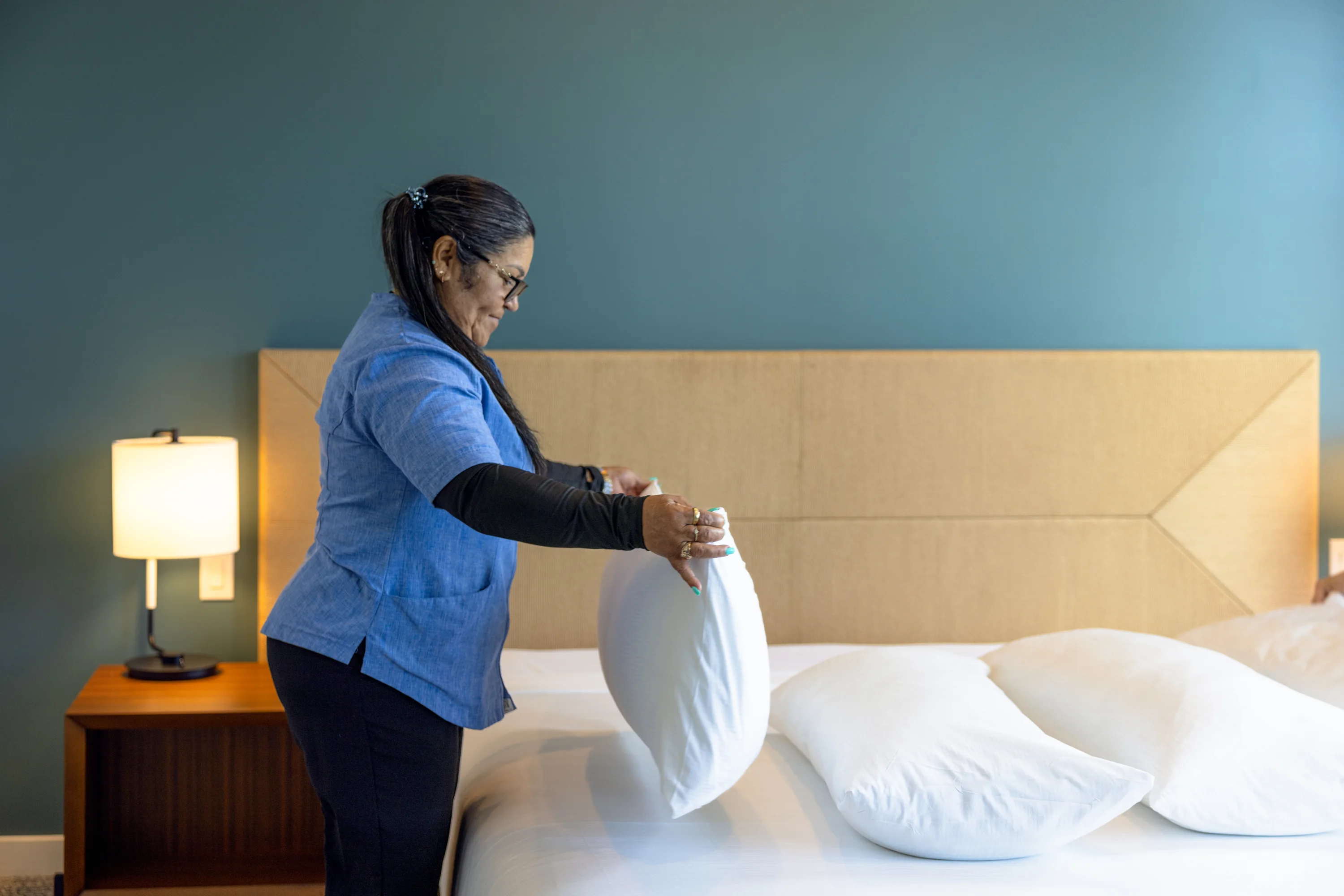 Housekeeping team member making a bed at Evermore Orlando Resort
