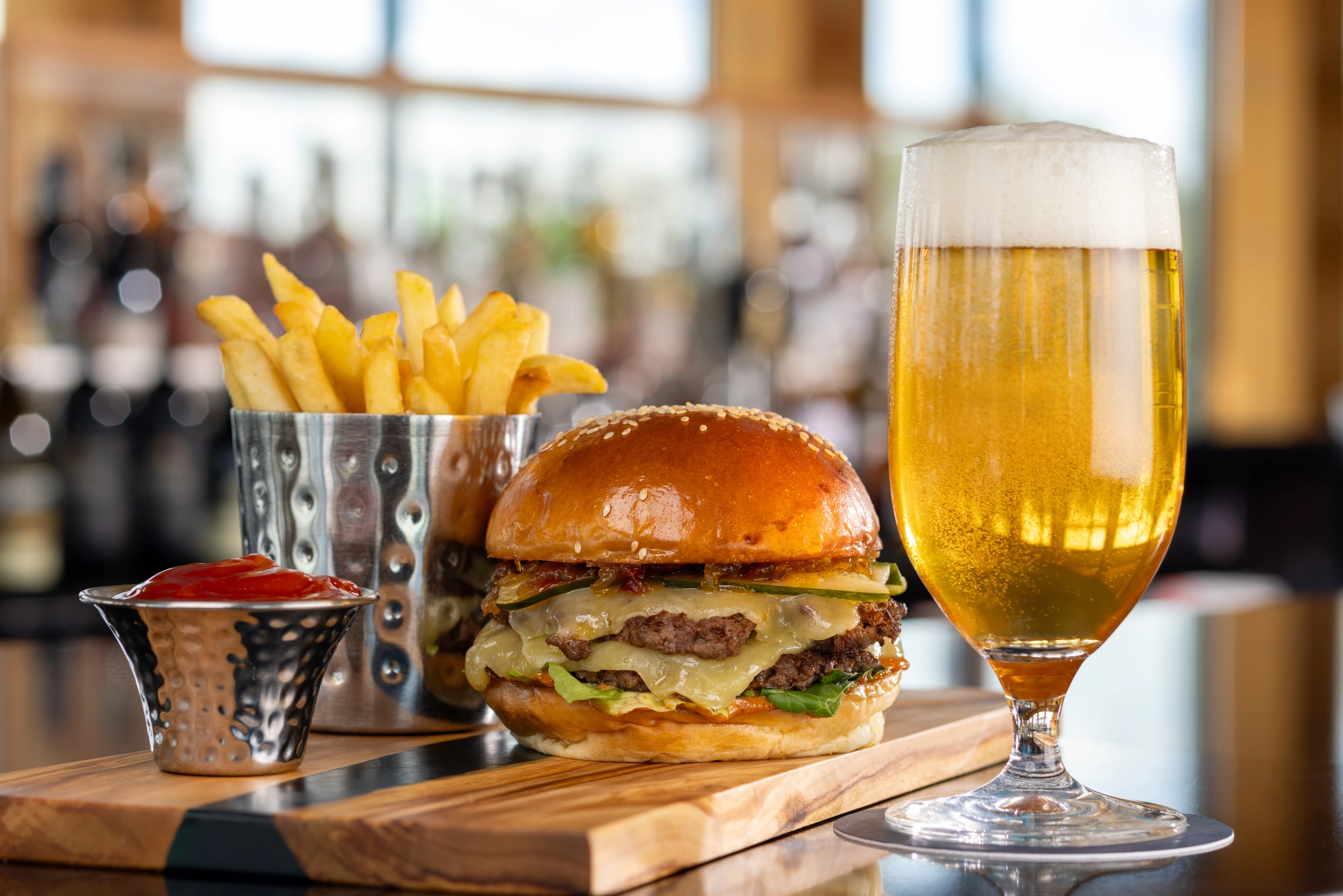 Smash burger with fries and beer at Evermore Orlando Resort