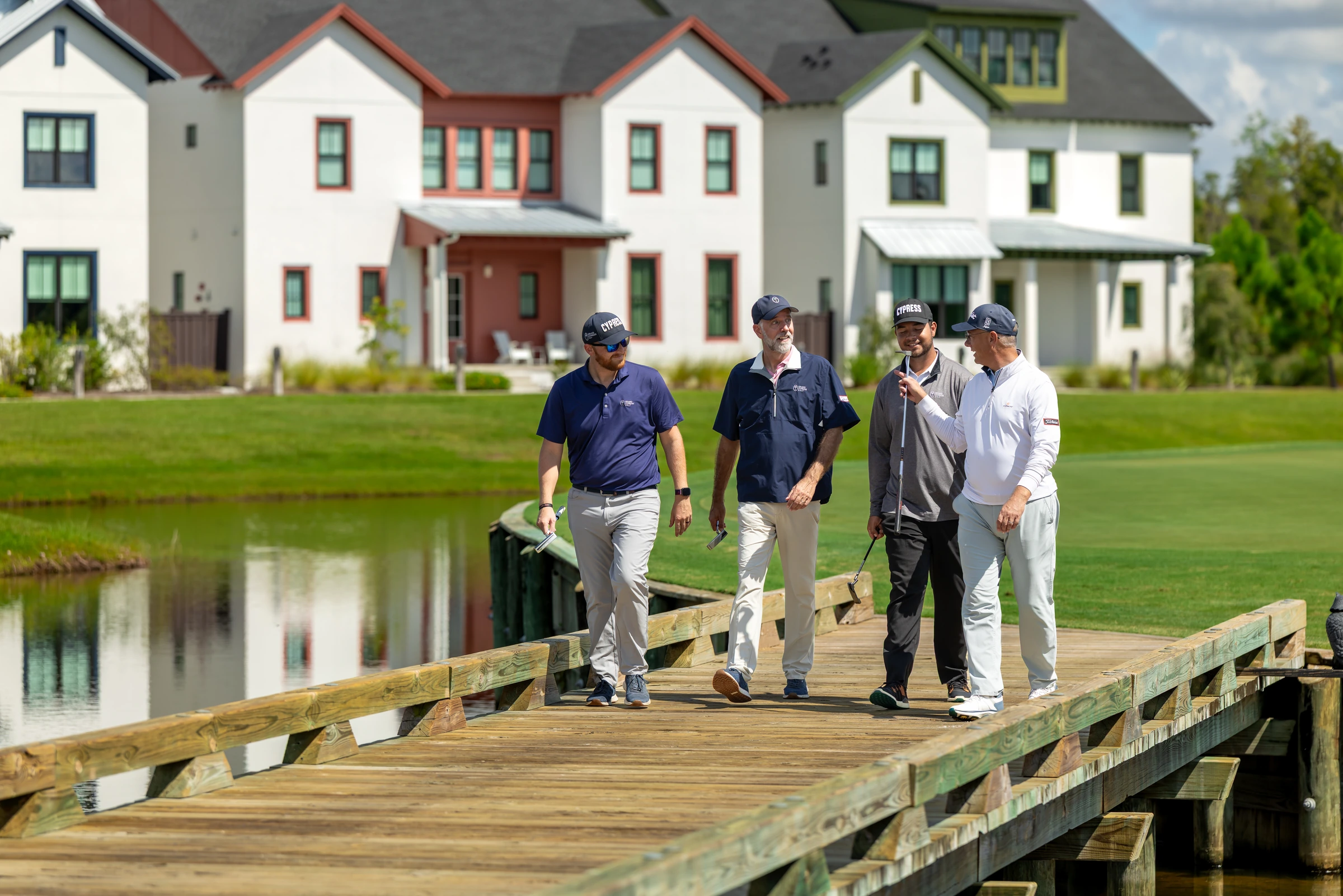 Golf group walking across a bridge at Evermore Orlando Resort