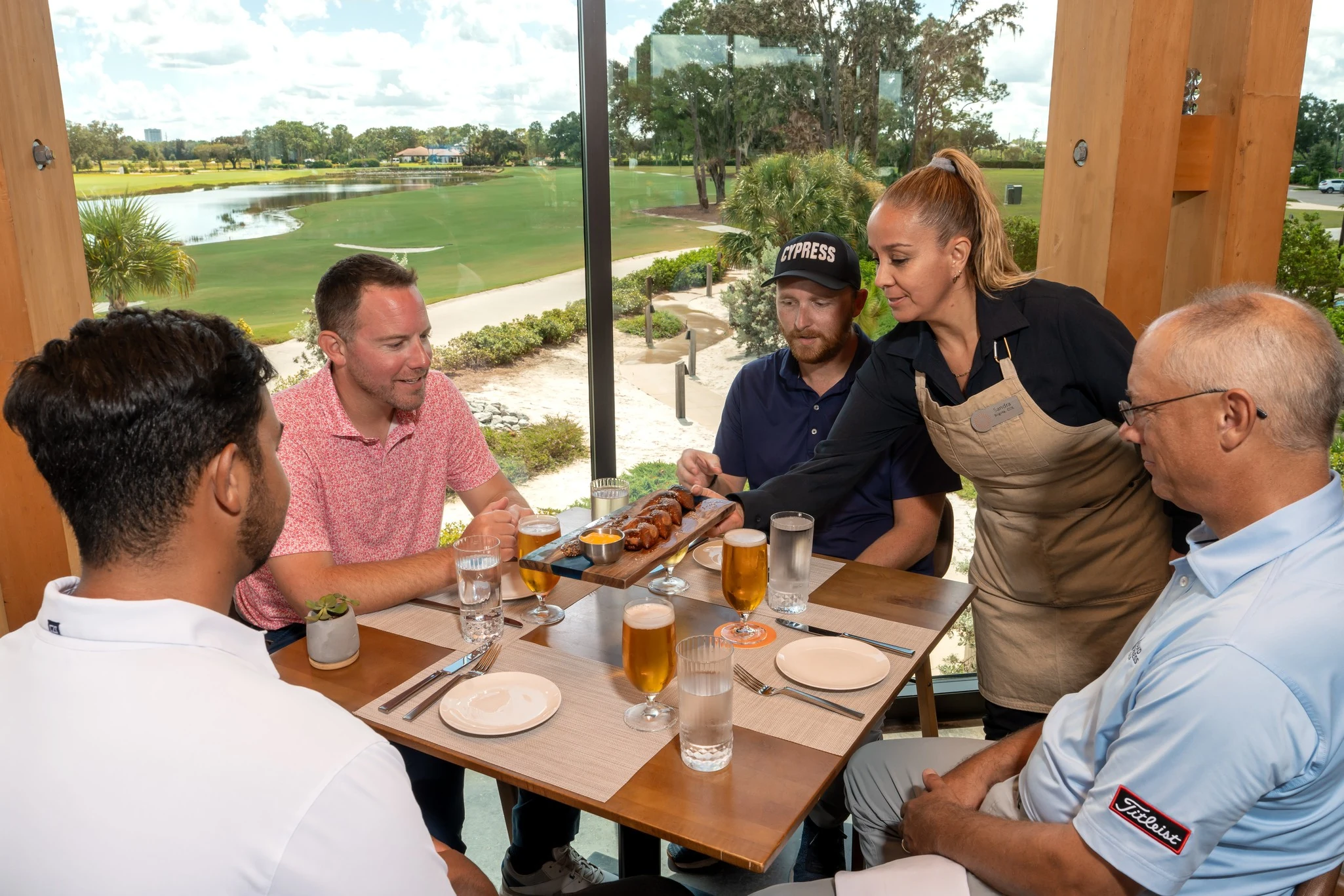 Golfers enjoying happy hour drinks and appetizers at Twin View