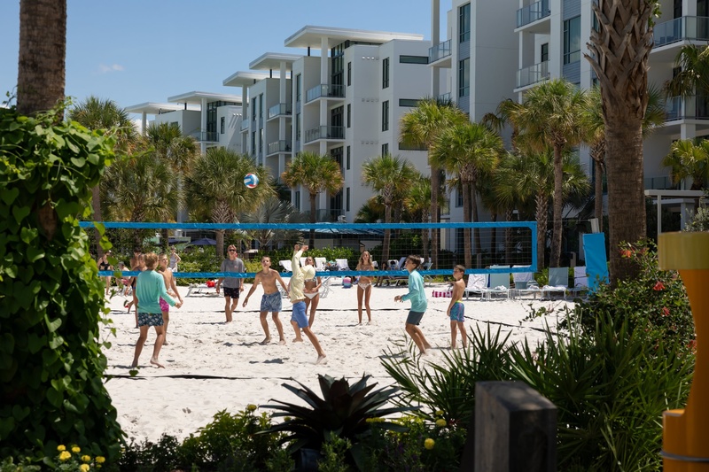 Guests playing sand volleyball at Evermore.
