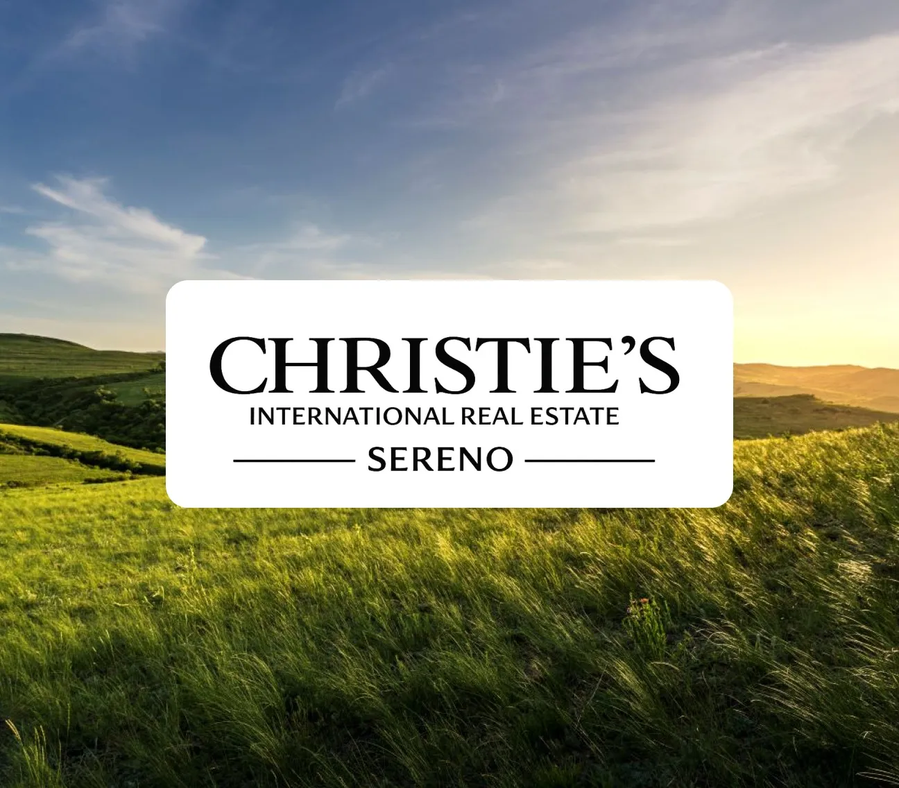 Christie's International Real Estate Sereno logo over grassy hills at sunset with blue sky.