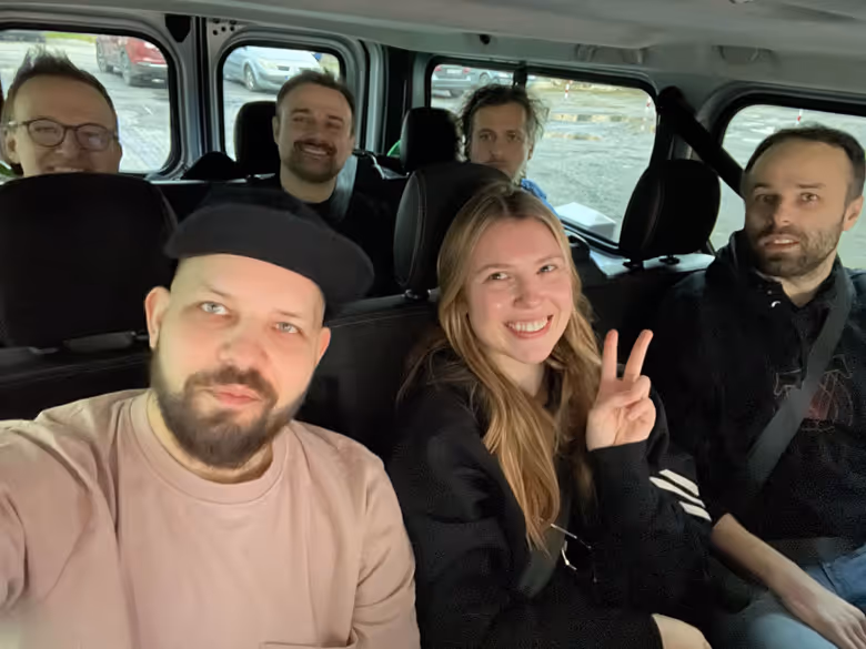 Six team members sitting in the van.